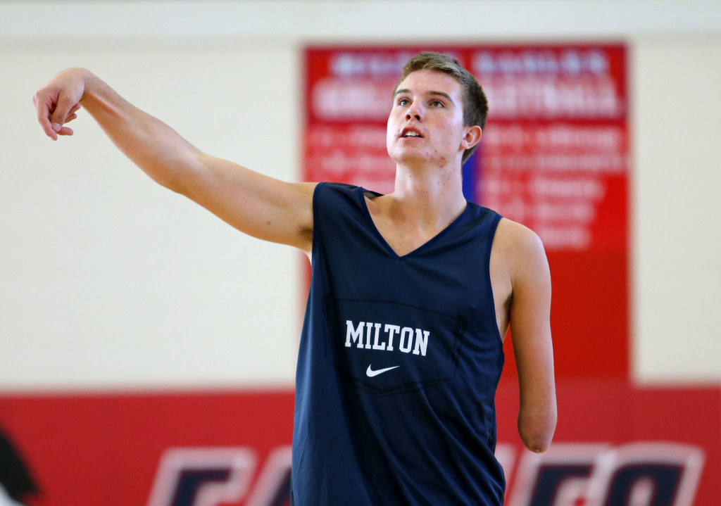 October 24, 2013 - Milton, Ga: Milton High School senior Zach Hodskins watches a shot as he works out with his father Bob (not pictured) in Milton's gymnasium Thursday afternoon in Milton, Ga., October 24, 2013. Hodskins, who was born without the lower half of his left arm, recently committed to the University of Florida as a preferred walk-on. Hodskins is recovering from a sprained ankle but he expects to start the upcoming high school basketball season. JASON GETZ / JGETZ@AJC.COM