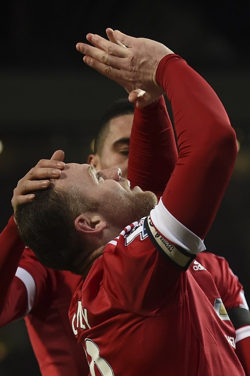Manchester United's English striker Wayne Rooney celebrates scoring their third goal during the English Premier League football match between Manchester United and Stoke City at Old Trafford in Manchester, north west England, on February 2, 2016. / AFP / PAUL ELLIS / RESTRICTED TO EDITORIAL USE. No use with unauthorized audio, video, data, fixture lists, club/league logos or 'live' services. Online in-match use limited to 75 images, no video emulation. No use in betting, games or single club/league/player publications. /